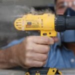 Close-up of a drill chuck showing signs of overheating, emphasizing the importance of cooling down power tools.