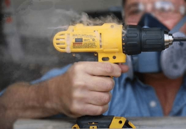 Close-up of a drill chuck showing signs of overheating, emphasizing the importance of cooling down power tools.