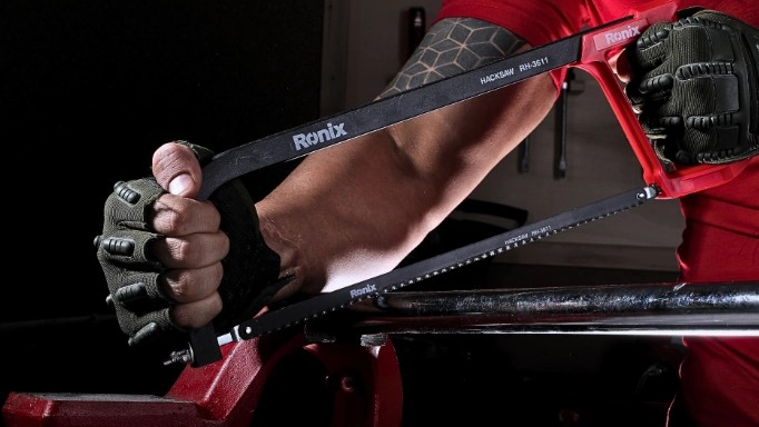 Man using a Hacksaw for metal