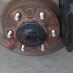 Front suspension and CV axle visible after wheel removal