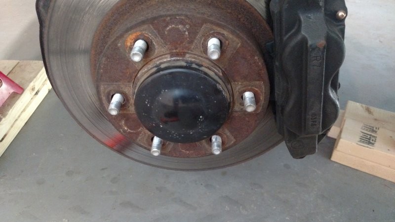 Front suspension and CV axle visible after wheel removal